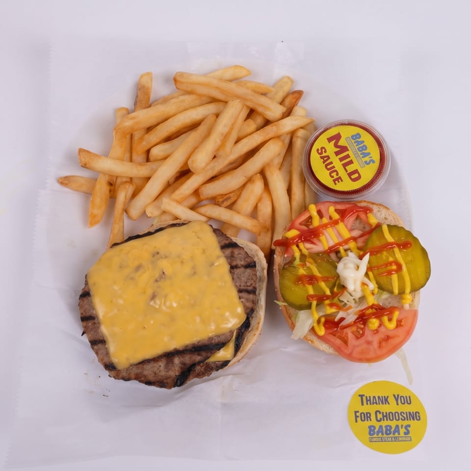 Overhead view of a cheeseburger, fries, Baba's Mild Sauce, and a "Thank You" sticker.